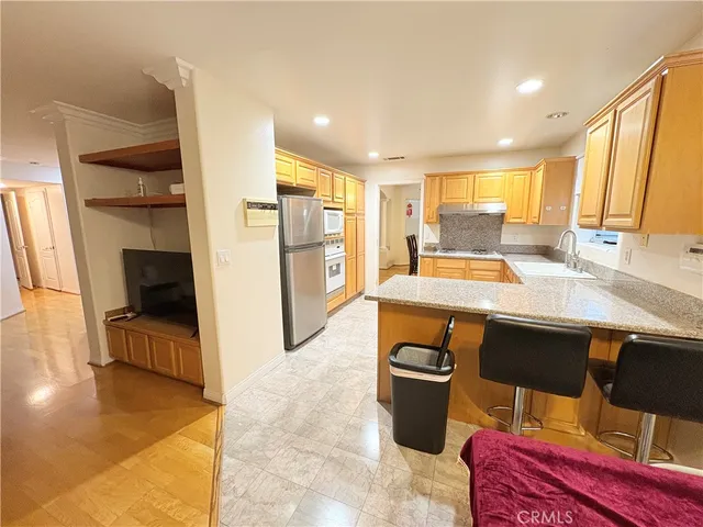 a kitchen with a sink appliances and cabinets