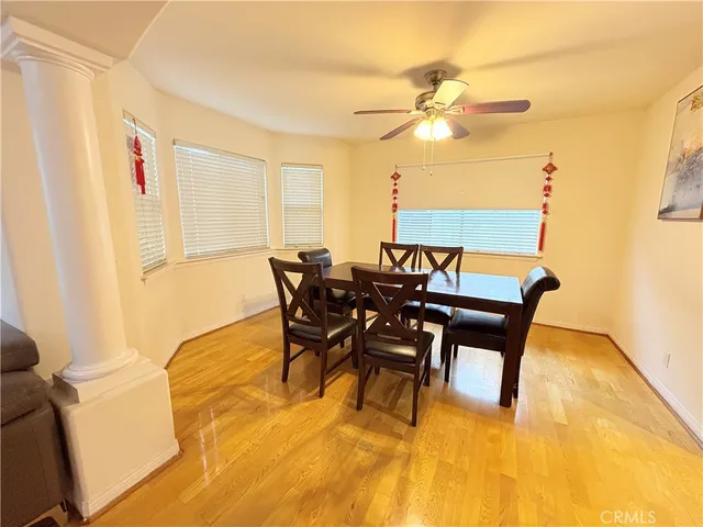 a view of a dining room with furniture and a chandelier