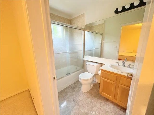 a bathroom with a toilet a sink and a shower