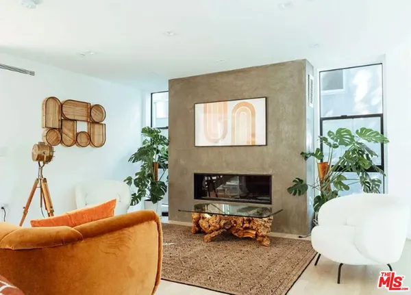 a living room with furniture a window and a fireplace