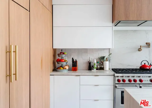 a kitchen with a refrigerator and cabinets