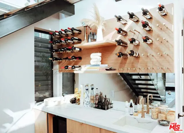 a view of a hallway with paintings on the wall and a window
