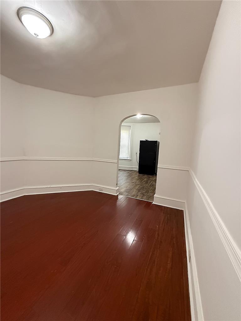 5107 Cottage Street, Unit 1 Philadelphia, PA 19124 - Photo 3 of 7 Warm wood floors and a seamless arched doorway create an inviting atmosphere.