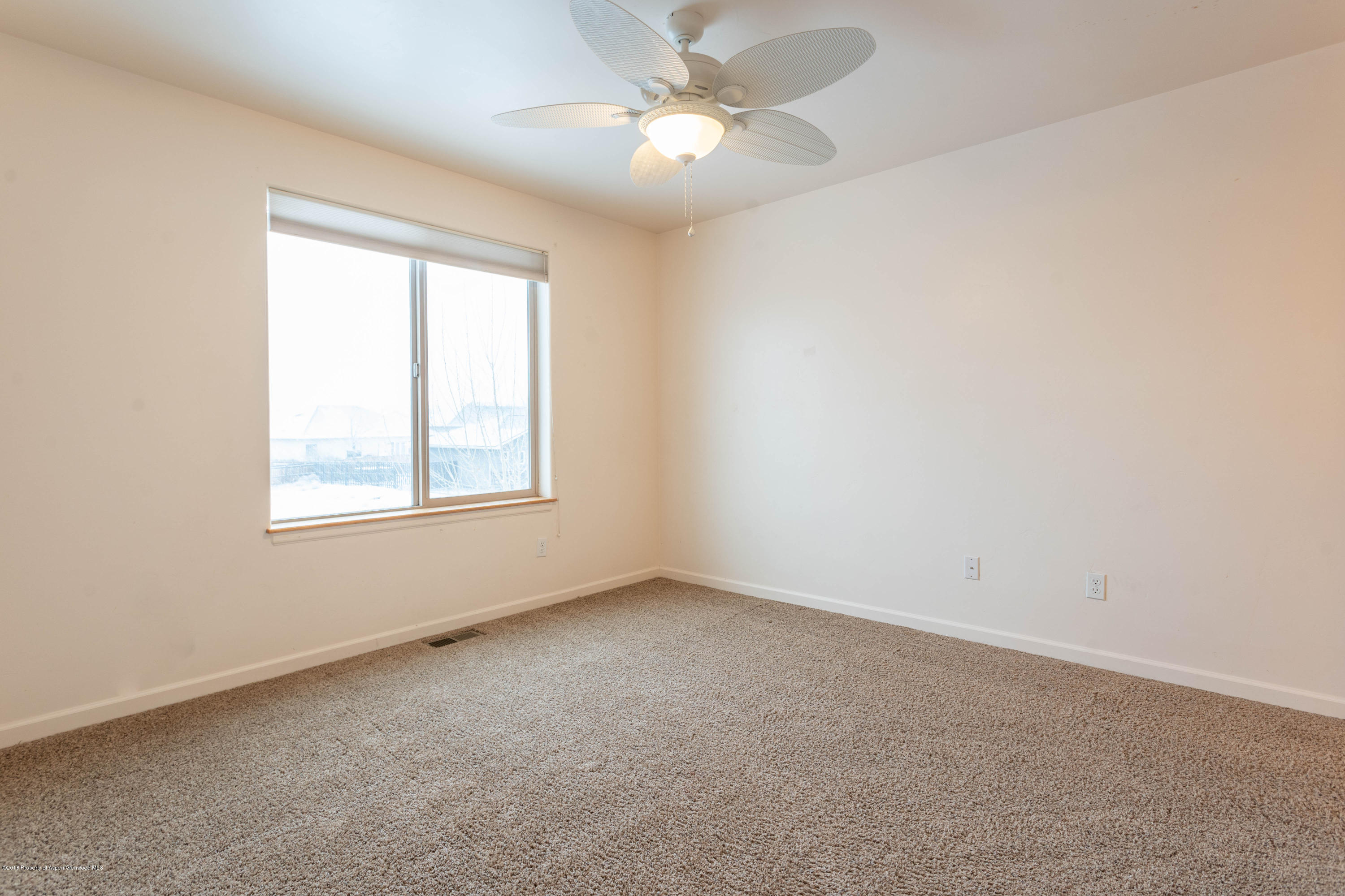 953 East 17th Street Rifle, CO 81650 - Photo 13 of 15 an empty room with a window and a fan