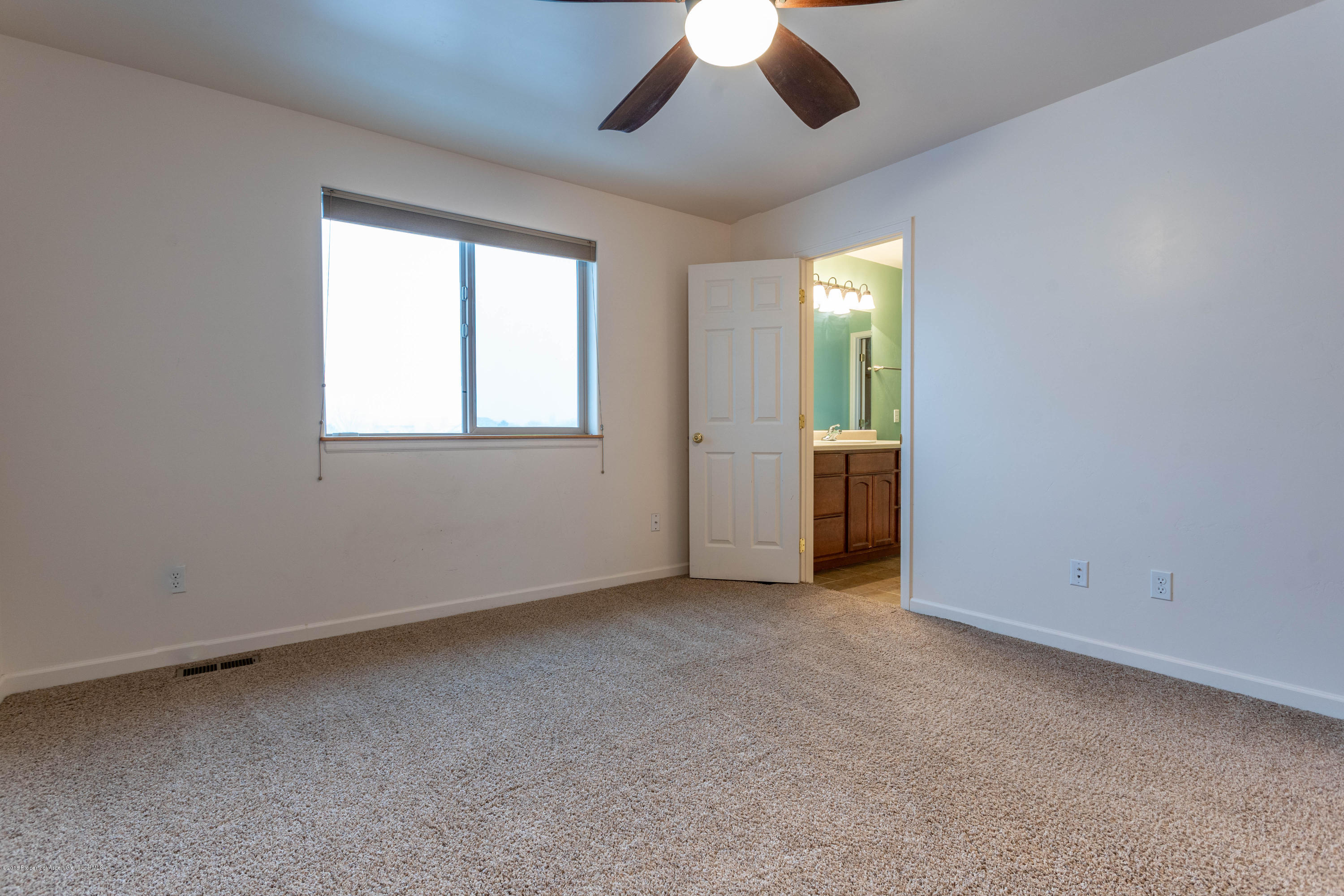953 East 17th Street Rifle, CO 81650 - Photo 9 of 15 an empty room with chandelier fan and windows