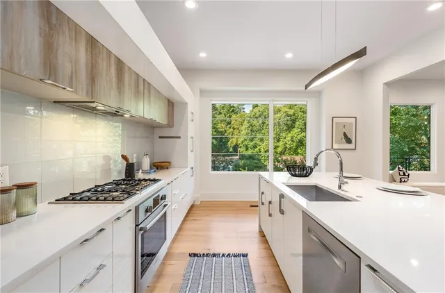 a kitchen with a sink stove and cabinets