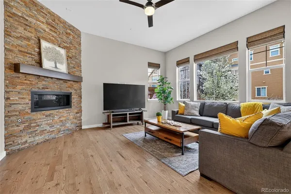 a living room with furniture a flat screen tv and a fireplace
