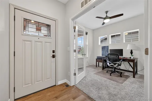 a view of a livingroom with workspace and a window