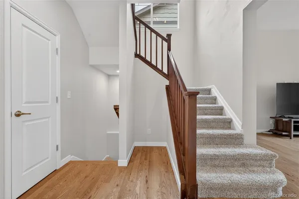 a view of entryway and hall with wooden floor