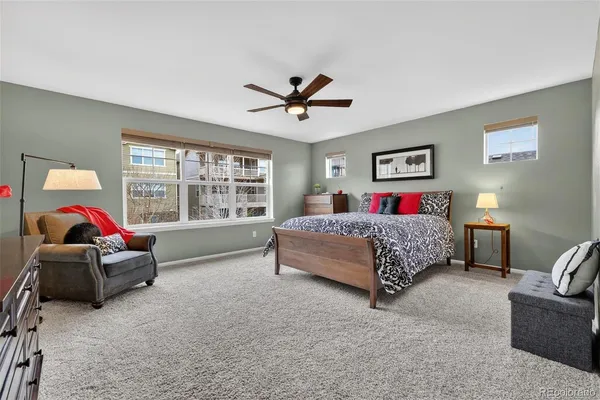 a bedroom with a bed and a painting on the wall