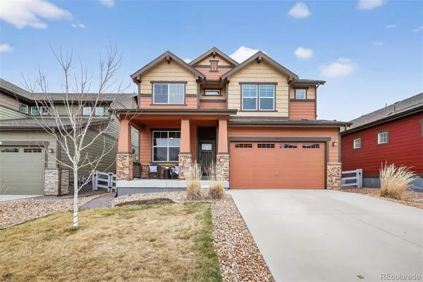 a front view of a house with a yard outdoor seating and garage