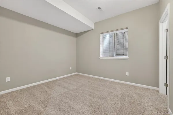 a bedroom with a bed and a lounge chair