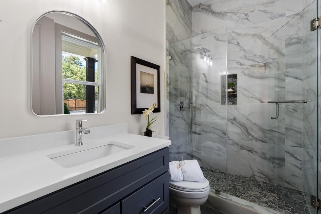 4611 Medlock Bridge Road Peachtree Corners, GA 30097 - Photo 14 of 36 a bathroom with a sink a toilet and a mirror