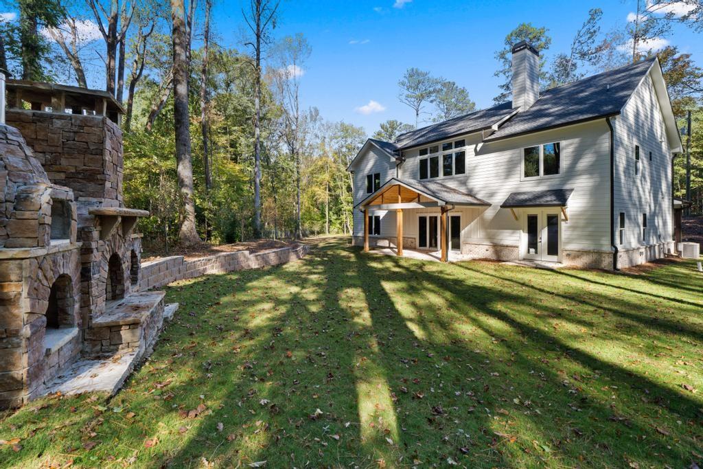 4611 Medlock Bridge Road Peachtree Corners, GA 30097 - Photo 22 of 36 a front view of house with a garden