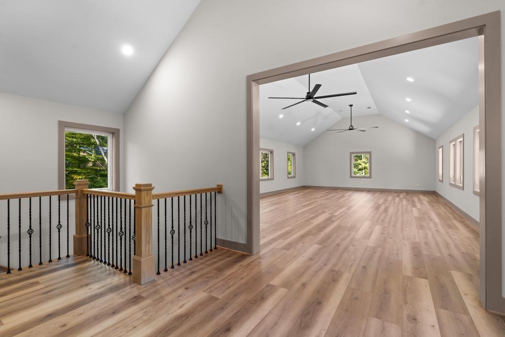 4611 Medlock Bridge Road Peachtree Corners, GA 30097 - Photo 25 of 36 wooden floor in a hall with a window and a chandelier fan