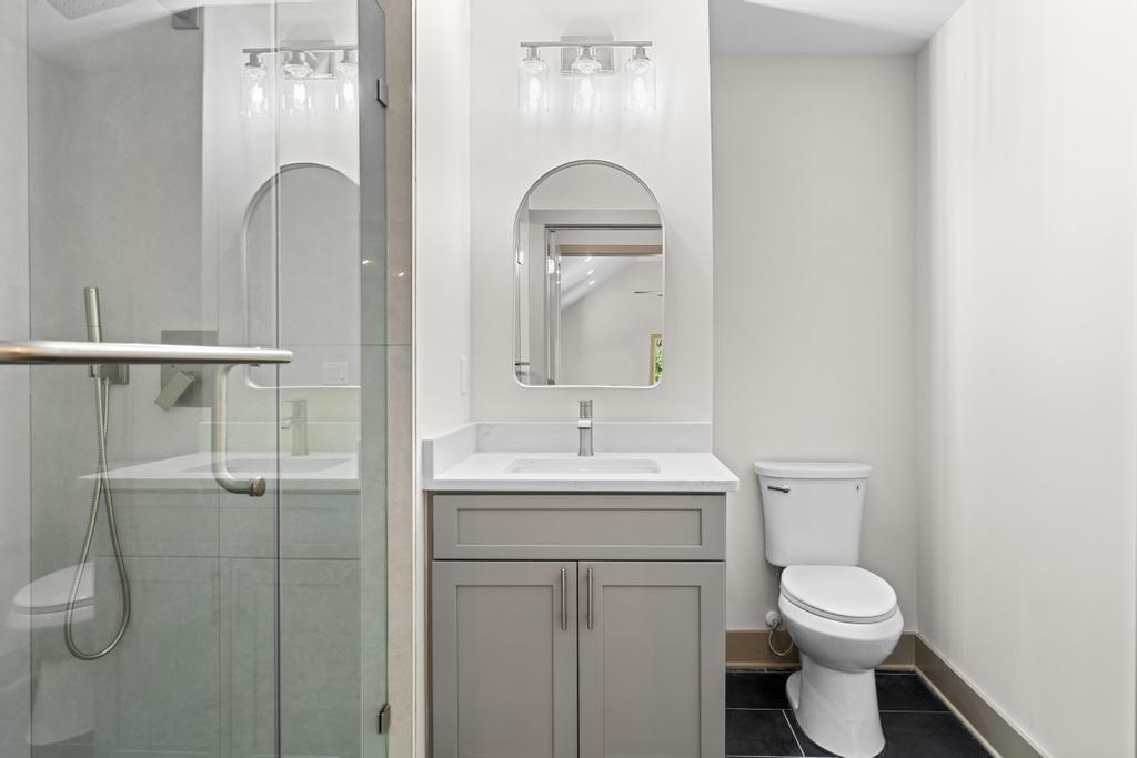 4611 Medlock Bridge Road Peachtree Corners, GA 30097 - Photo 27 of 36 a bathroom with a toilet sink and mirror