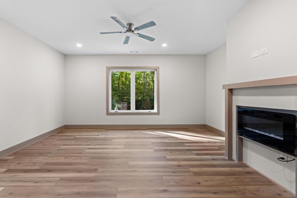 4611 Medlock Bridge Road Peachtree Corners, GA 30097 - Photo 31 of 36 a view of an empty room with a fireplace and a window
