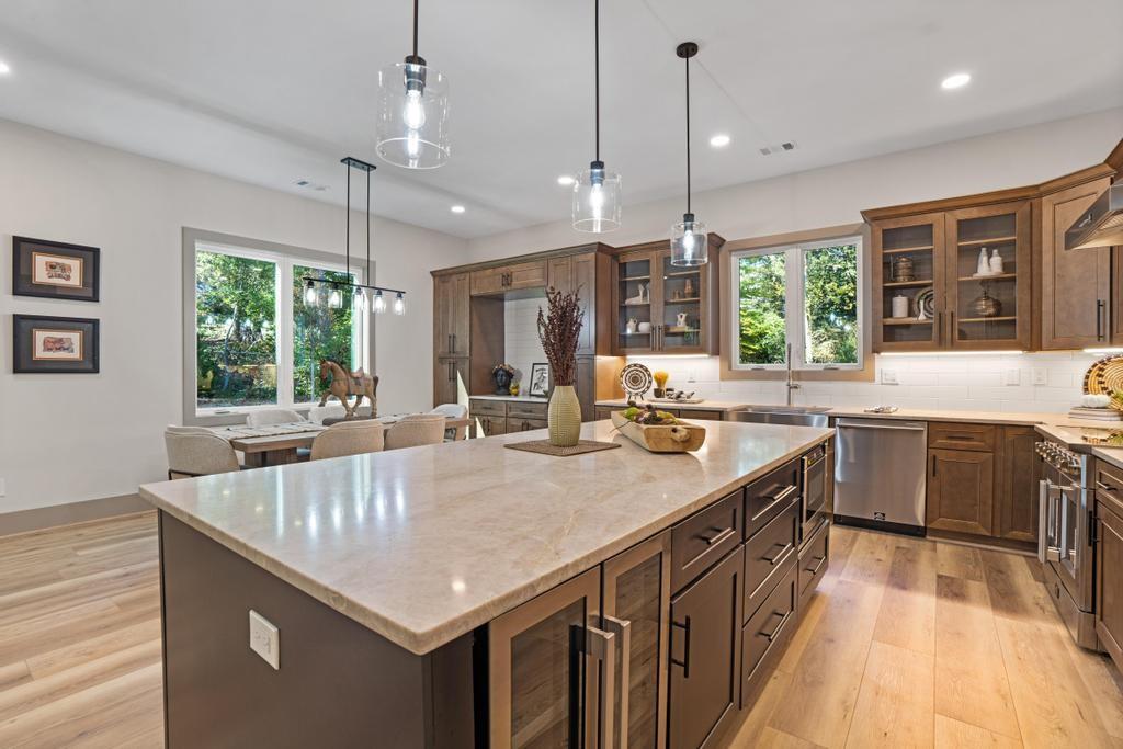 4611 Medlock Bridge Road Peachtree Corners, GA 30097 - Photo 8 of 36 a kitchen with granite countertop a sink a counter top space appliances and windows