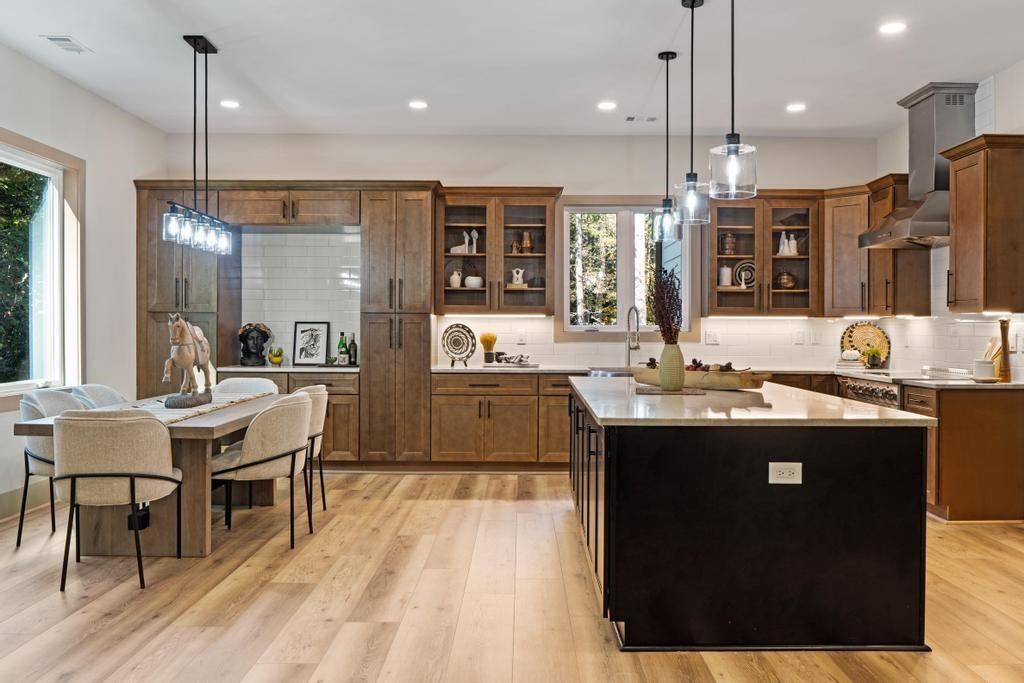 4611 Medlock Bridge Road Peachtree Corners, GA 30097 - Photo 9 of 36 a kitchen with kitchen island granite countertop a sink appliances and cabinets