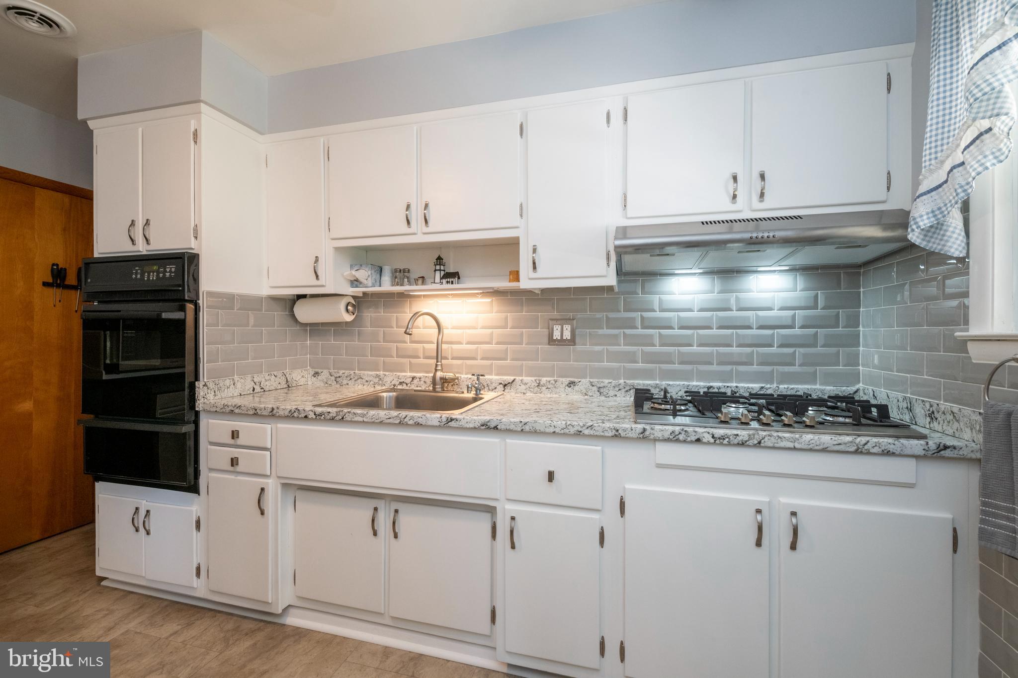 8209 Old Philadelphia Road Rosedale, MD 21237 - Photo 11 of 35 Updated kitchen with subway tile backsplash