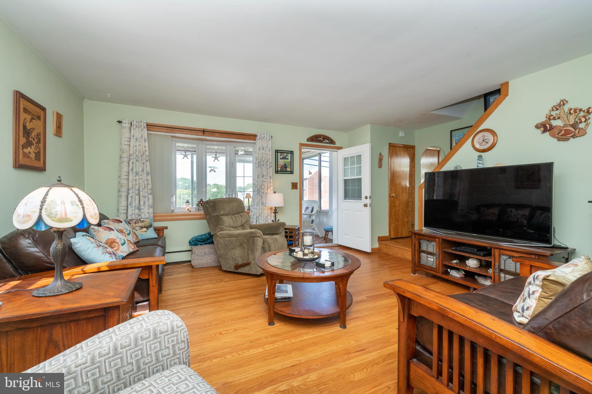 8209 Old Philadelphia Road Rosedale, MD 21237 - Photo 5 of 35 Living room with bay window and hardwood floors
