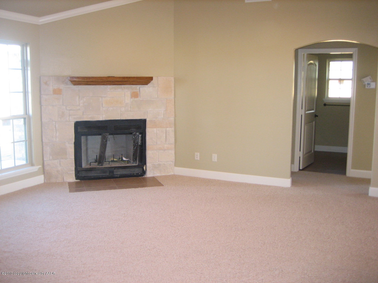 3811 Arden Road Amarillo, TX 79118 - Photo 3 of 16 an empty room with a fireplace and window