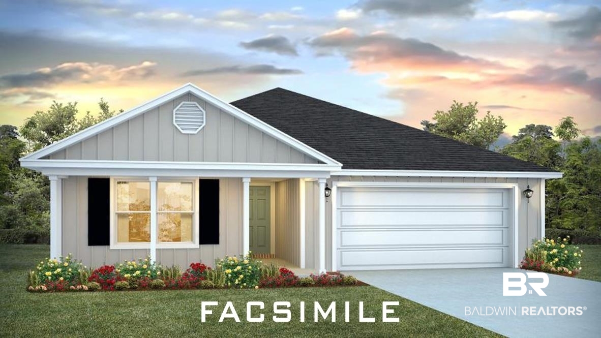 View of front of home with a yard and a garage