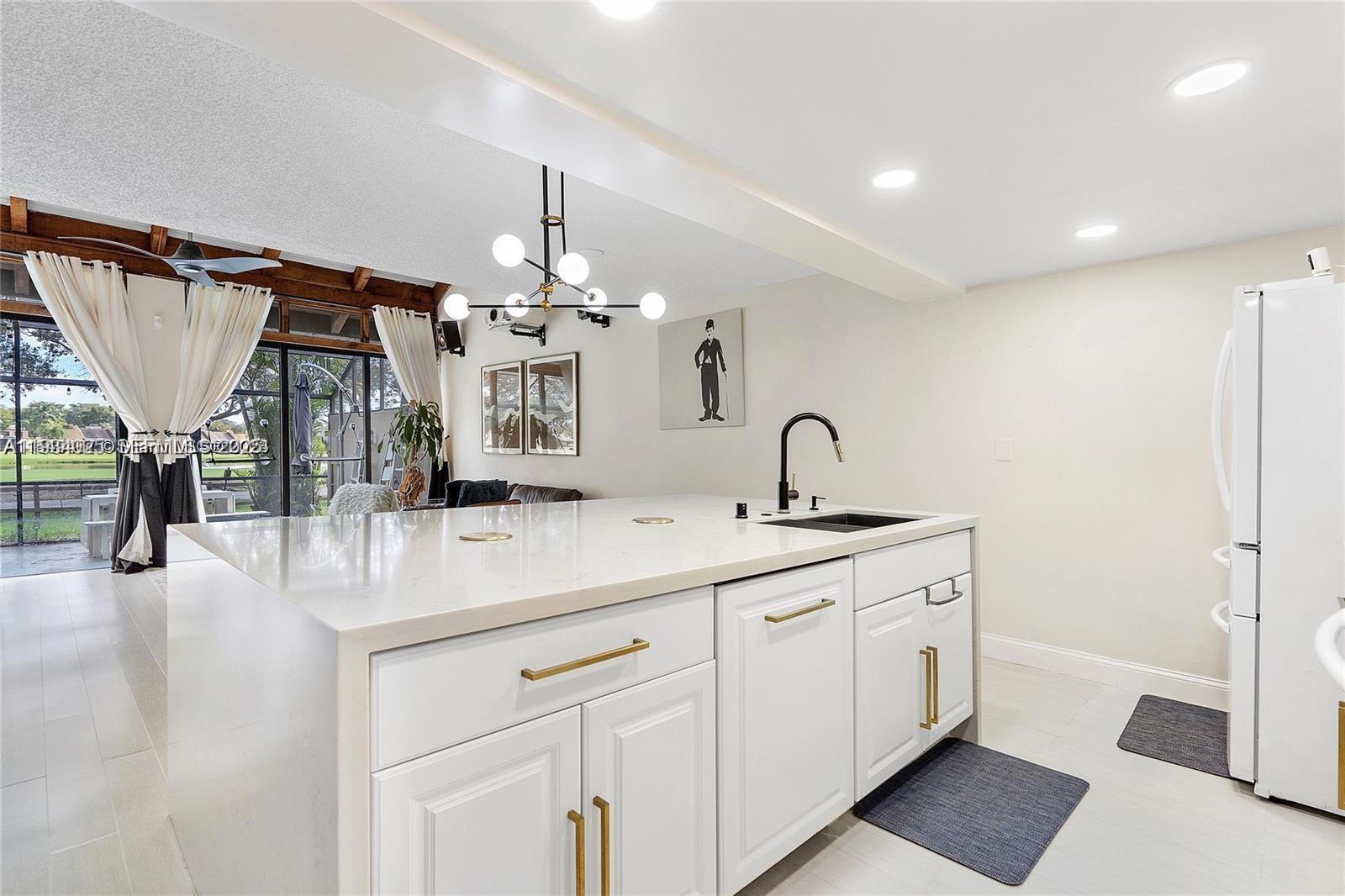 1281 West Fairway Road Pembroke Pines, FL 33026 - Photo 13 of 29 a kitchen with a sink and a stove top oven