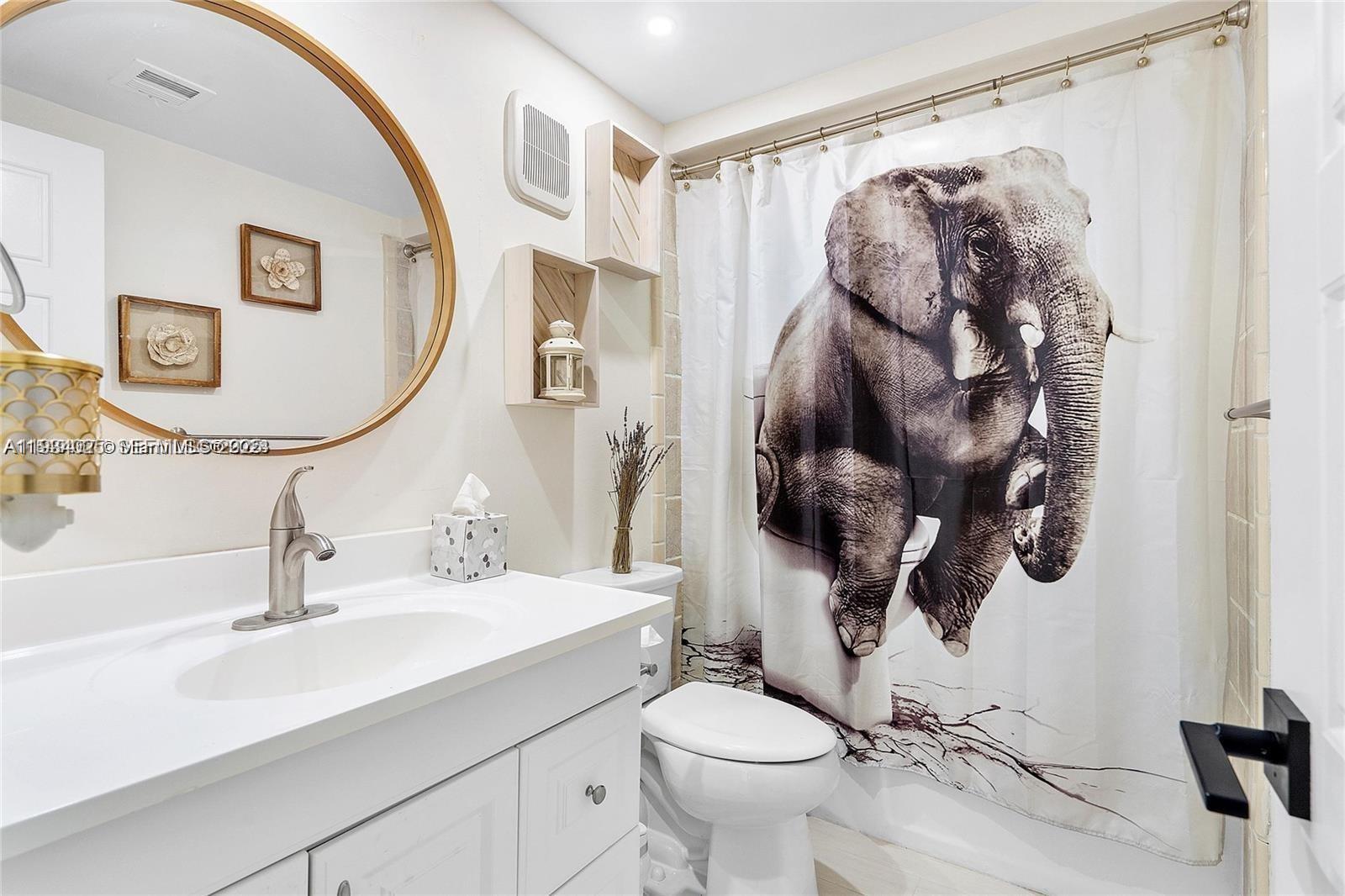 1281 West Fairway Road Pembroke Pines, FL 33026 - Photo 15 of 29 a bathroom with a toilet sink and mirror