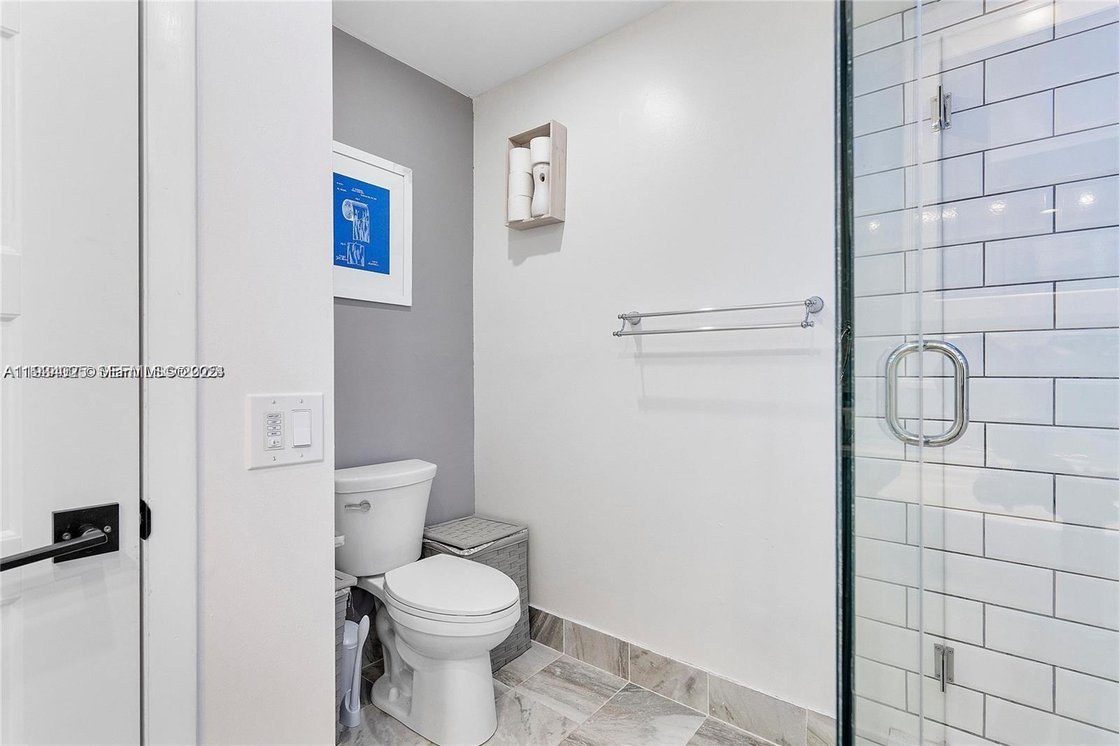 1281 West Fairway Road Pembroke Pines, FL 33026 - Photo 17 of 29 a white toilet sitting next to a bathroom sink