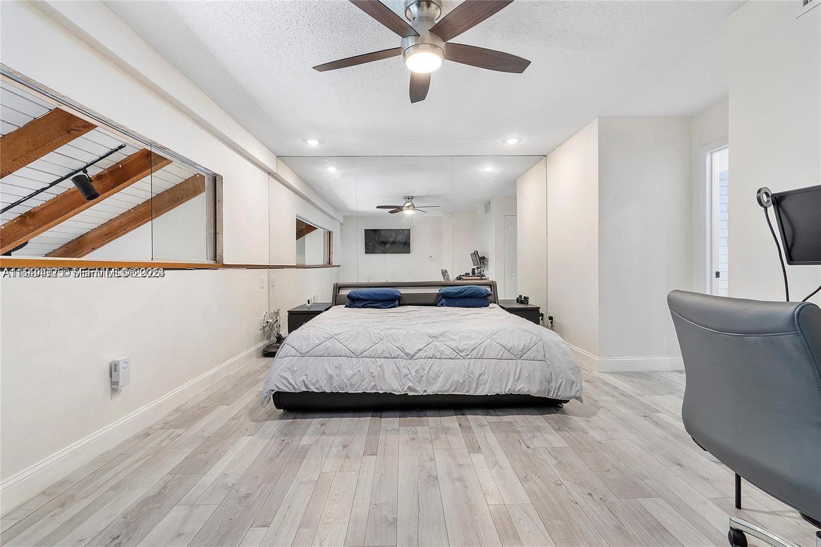 1281 West Fairway Road Pembroke Pines, FL 33026 - Photo 20 of 29 a spacious bedroom with a bed and a ceiling fan