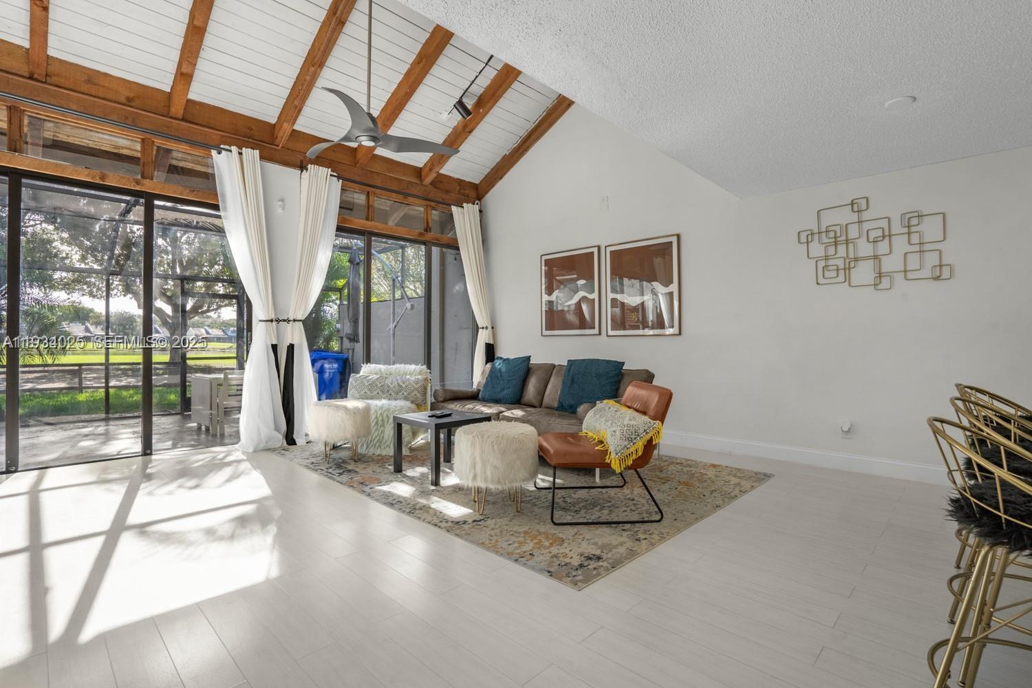 1281 West Fairway Road Pembroke Pines, FL 33026 - Photo 25 of 29 a living room with furniture and a floor to ceiling window