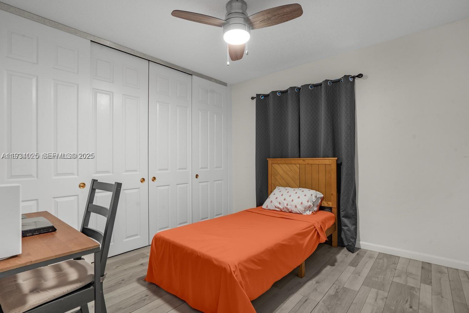 1281 West Fairway Road Pembroke Pines, FL 33026 - Photo 26 of 29 a bedroom with a bed and chair