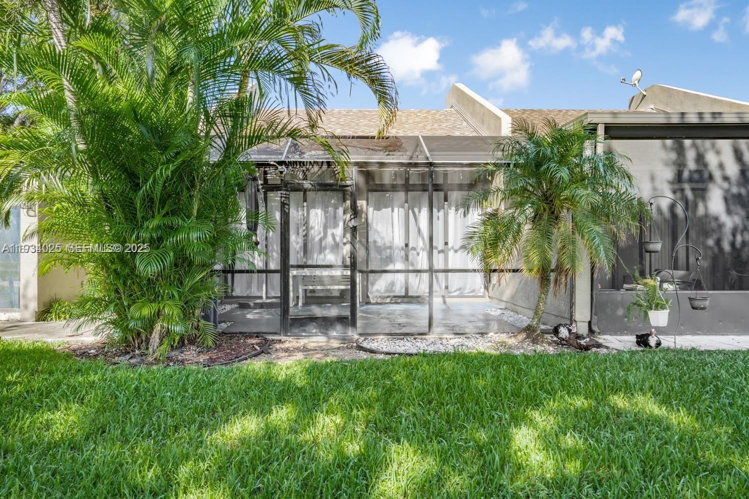 1281 West Fairway Road Pembroke Pines, FL 33026 - Photo 28 of 29 a view of a backyard with a patio and plants
