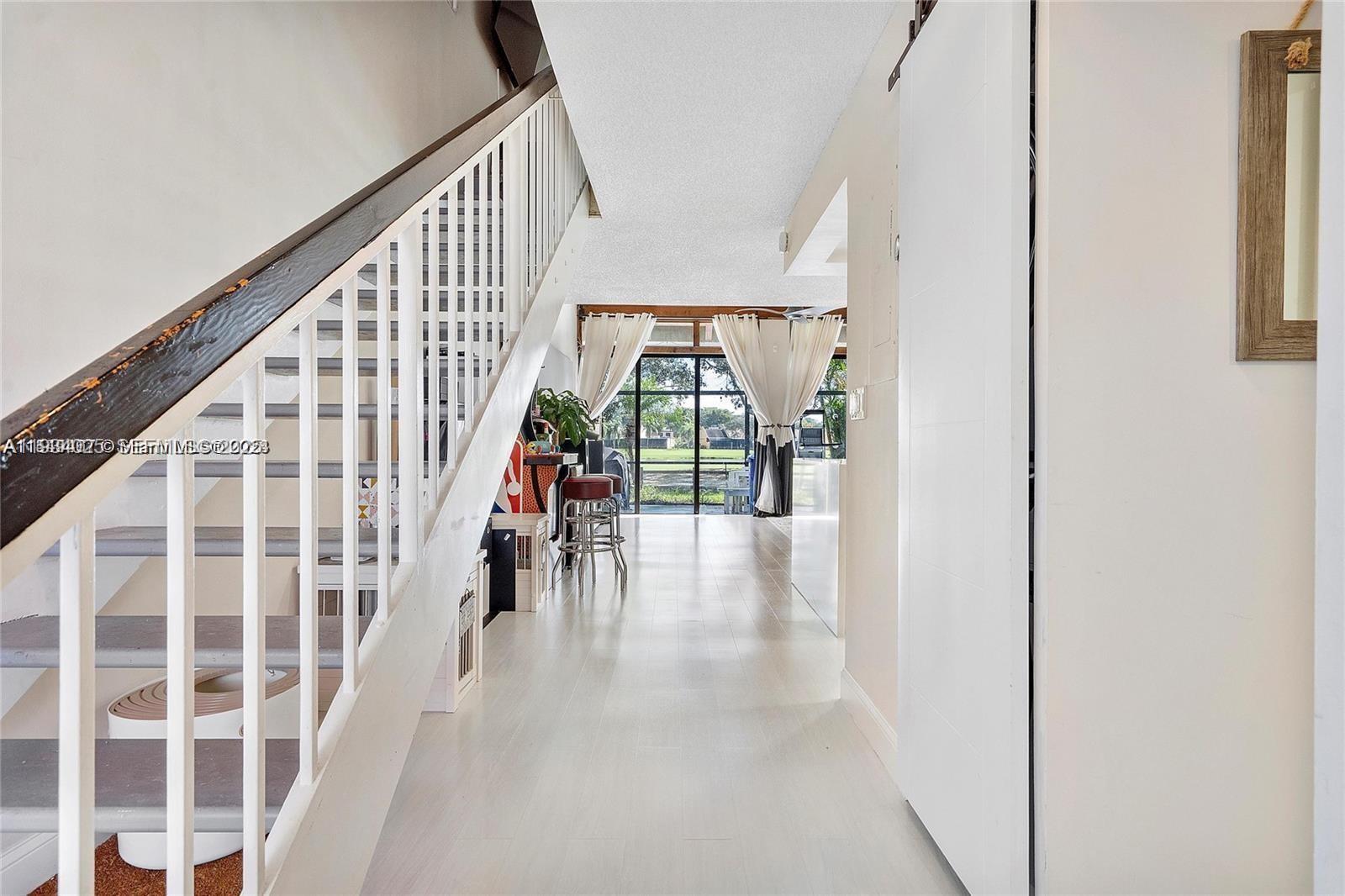 1281 West Fairway Road Pembroke Pines, FL 33026 - Photo 8 of 29 a view of staircase with wooden floor and windows