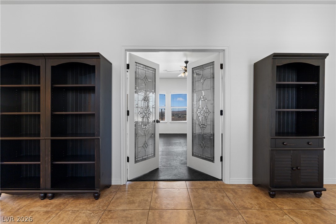 575 Gann Avenue Logandale, NV 89021 - Photo 5 of 75 Enter through elegant French doors into a versatile space offering sweeping outdoor views.