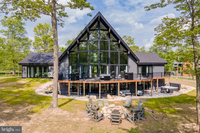 a view of a patio with table and chairs with wooden floor and fence