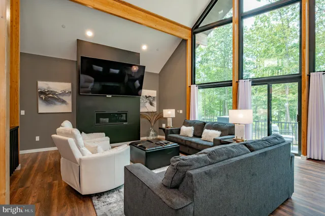 a bedroom with a bed and a flat tv screen on dresser