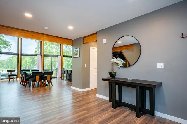 a bedroom with a bed a chair and a flat screen television