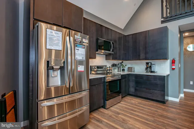 a en suite bathroom with a double vanity sink a toilet a mirror and shower