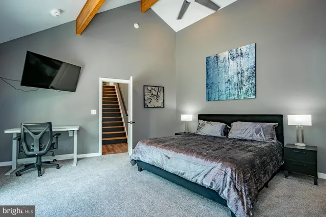 a living room with furniture a wooden floor and potted plant