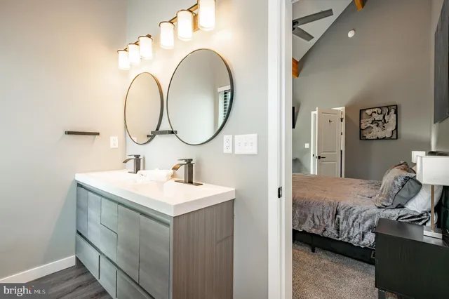 a living room with furniture a flat screen tv and kitchen view