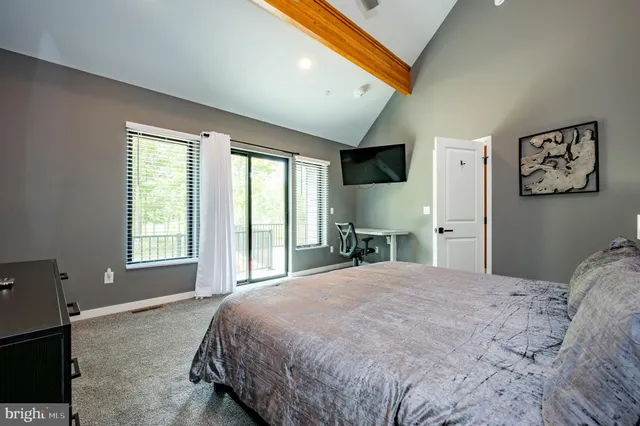 a bedroom with a large bed and a large window