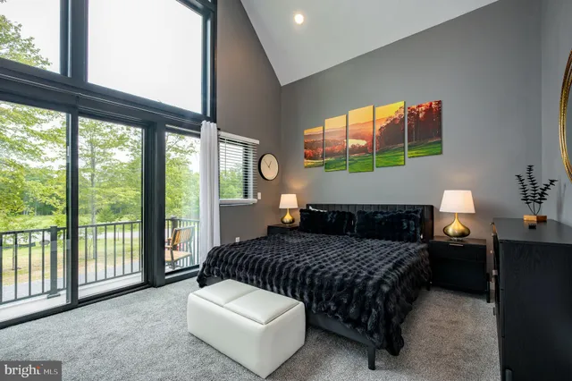 a bedroom with a large bed and a flat screen tv