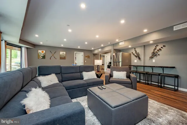 a view of a house with a large tree and a yard in front of it