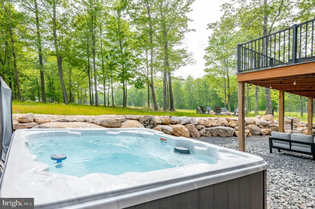 a living room with fireplace furniture and a large window