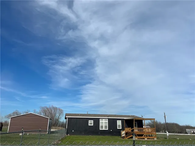 a view of houses with yard and city view