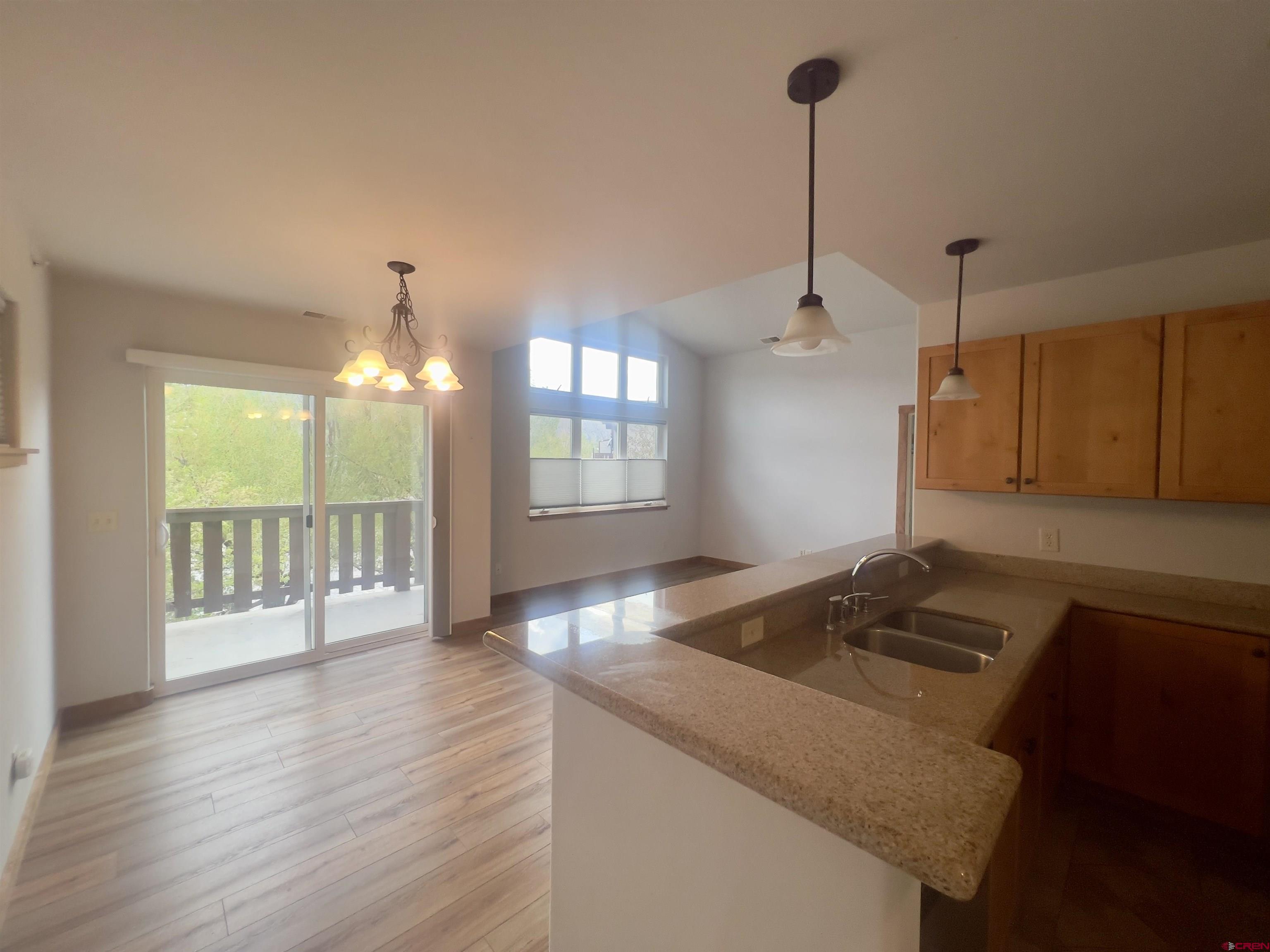 540 Redcliff Circle, Unit E 203 Ridgway, CO 81432 - Photo 7 of 36 a kitchen that has a lot of furniture and window in it