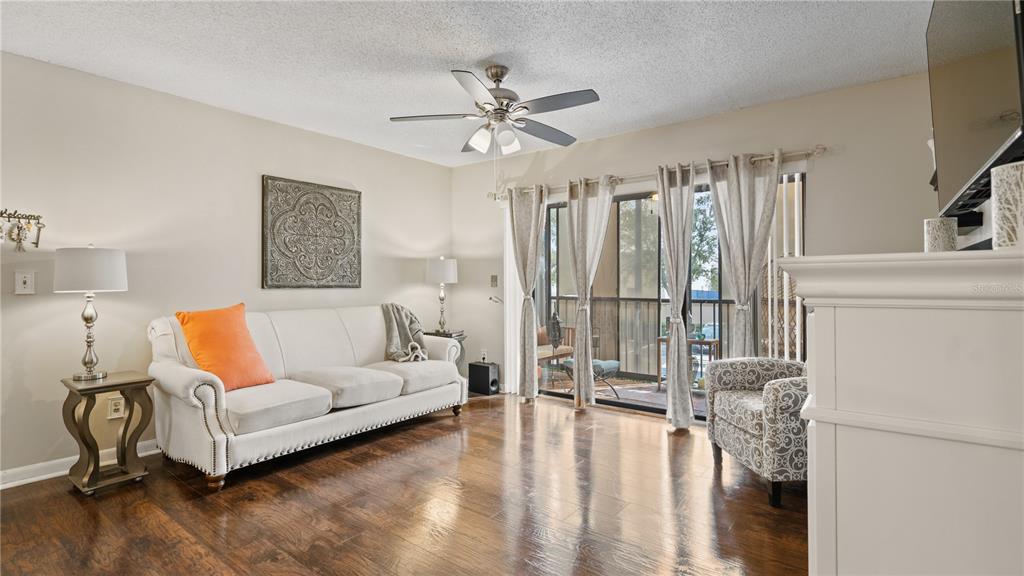 8203 Sun Spring Circle, Unit 12 Orlando, FL 32825 - Photo 16 of 38 a living room with furniture and a chandelier