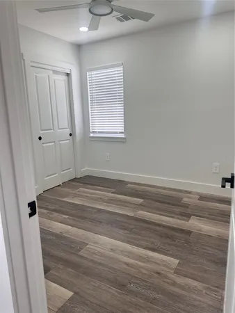 a bathroom with a window and a chandelier fan